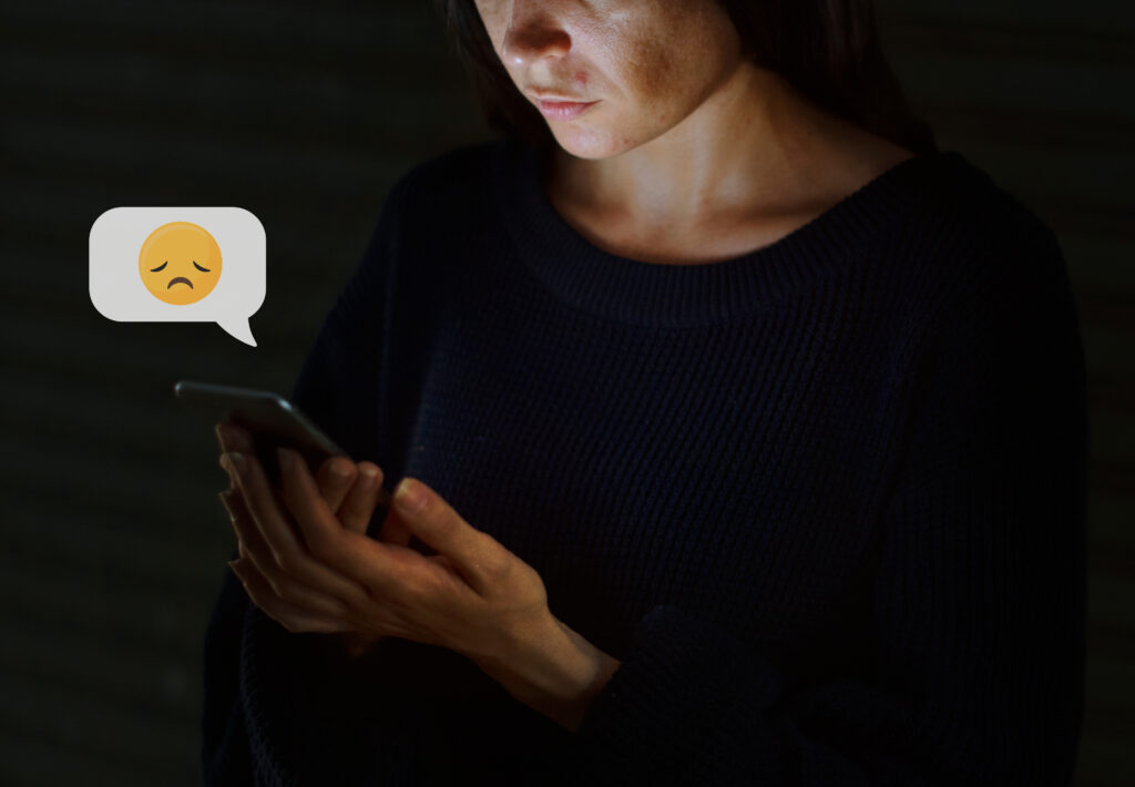 Woman using her mobile phone in the dark